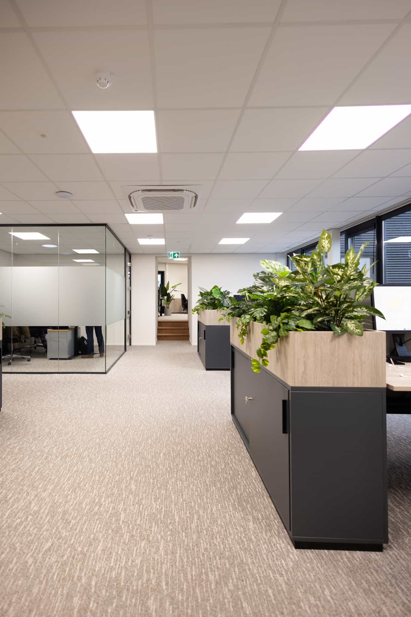 Modern kantoorinrichting met kasten en plantenbakken